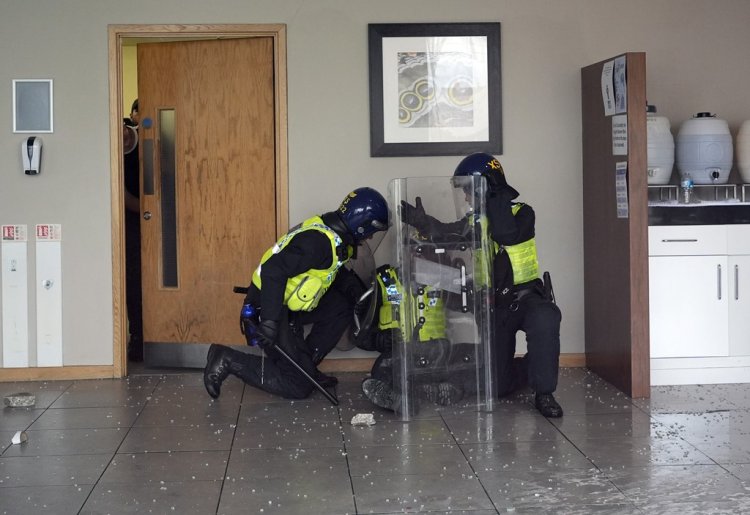 UK protests: Masked group smash windows at hotel in Rotherham - as police given extra powers in Bolton